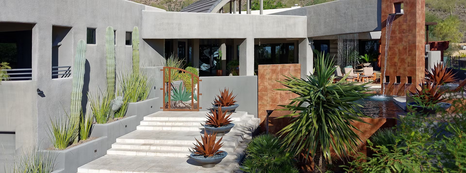 Modern desert courtyard with water feature and cacti